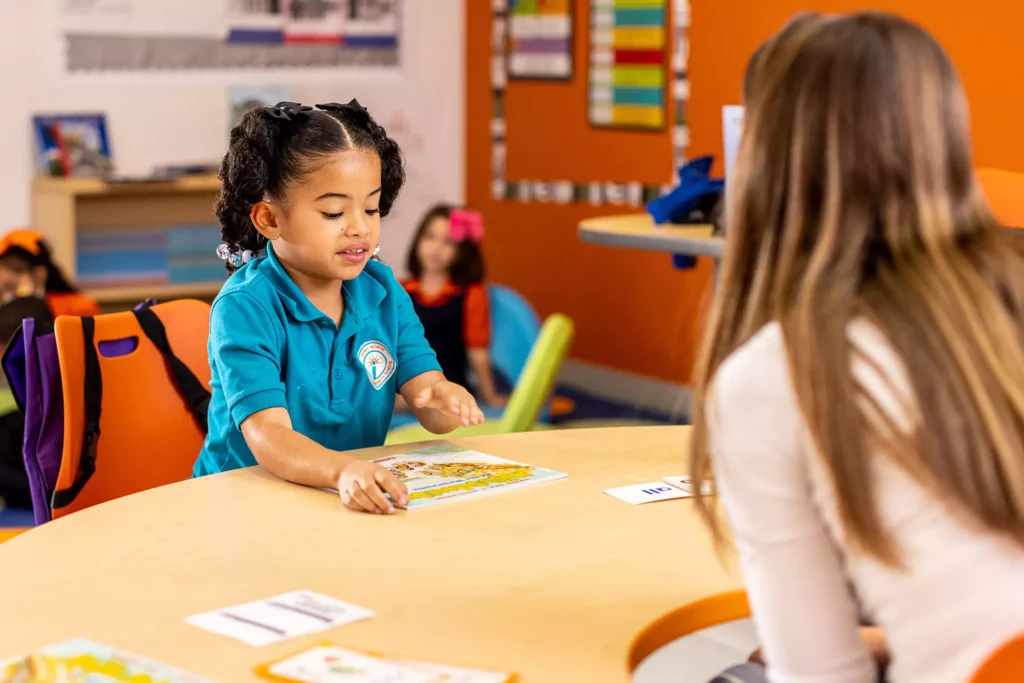 student talking to teacher about book