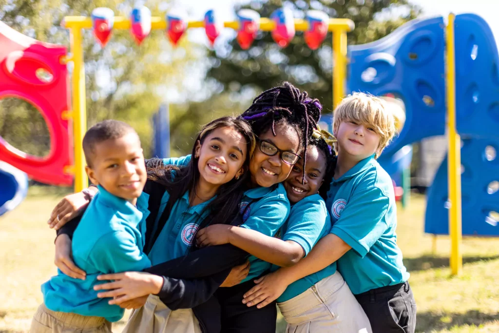 students smiling and playing outside with classmates